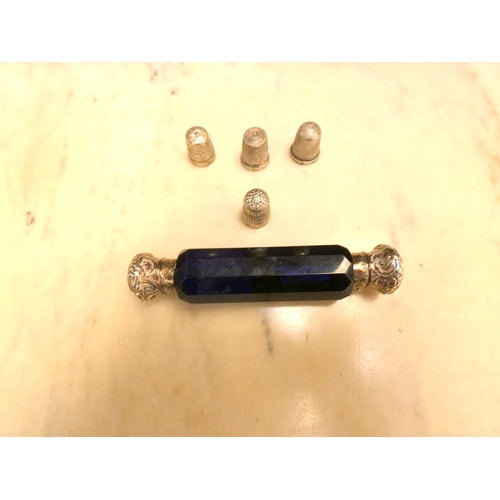 502 - Four silver thimbles and Bristol blue glass scent bottle with twin silver tops.