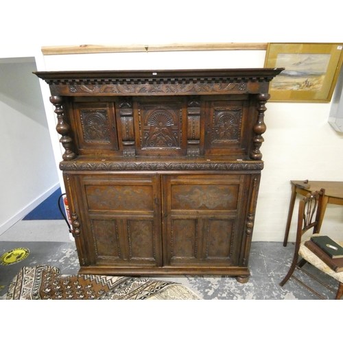 506 - Early 19th century oak court cupboard with three carved doors to top.