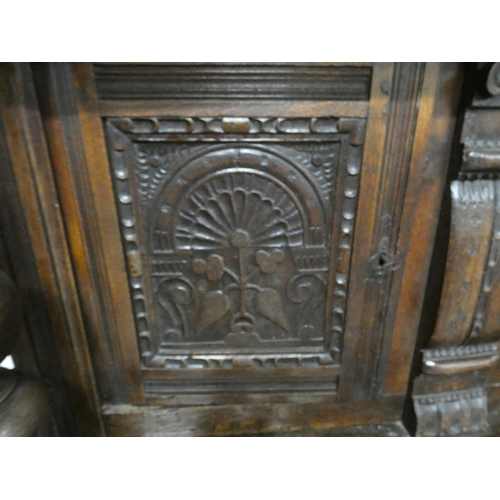 506 - Early 19th century oak court cupboard with three carved doors to top.