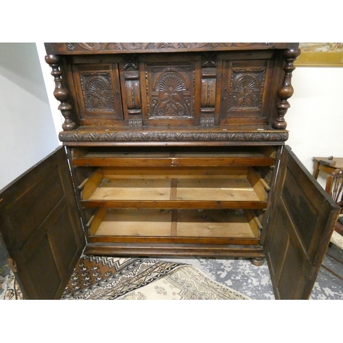 506 - Early 19th century oak court cupboard with three carved doors to top.