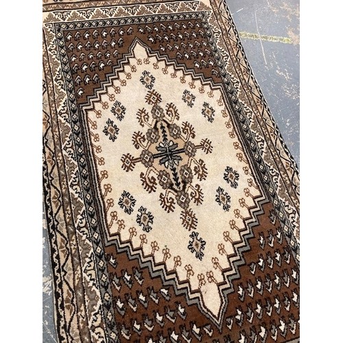 507 - Persian design brown and white rug.