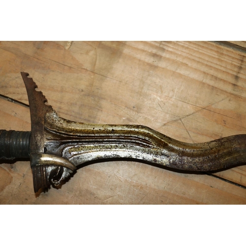 1553 - Malaysian kris with typical ornate flamberge blade, white metal wire bound grip and ivory birds head... 