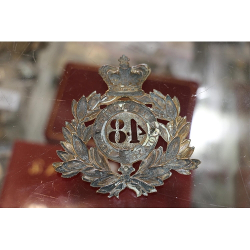 1494 - Helmet plate of the 48th Northampton Regiment, a south Wales Borderers cap badge, a Glengarry with L... 