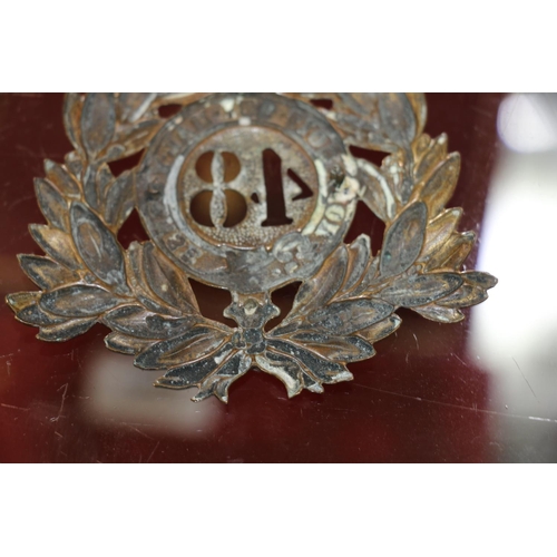 1494 - Helmet plate of the 48th Northampton Regiment, a south Wales Borderers cap badge, a Glengarry with L... 