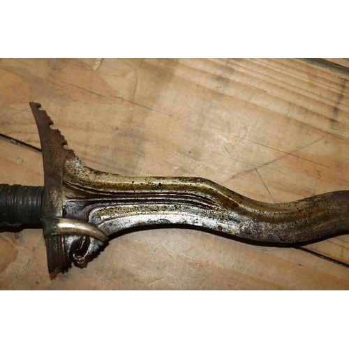 1553 - Malaysian kris with typical ornate flamberge blade, white metal wire bound grip and ivory birds head... 