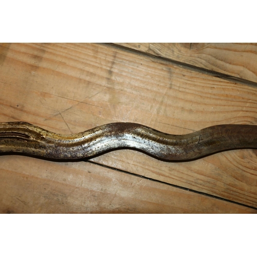 1553 - Malaysian kris with typical ornate flamberge blade, white metal wire bound grip and ivory birds head... 