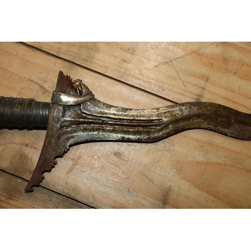 1553 - Malaysian kris with typical ornate flamberge blade, white metal wire bound grip and ivory birds head... 
