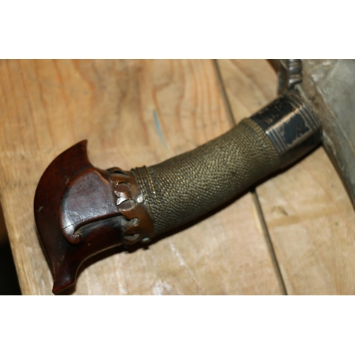 1554 - Malaysian kris with typical ornate flamberge blade, white metal wire bound grip and treen birds head... 