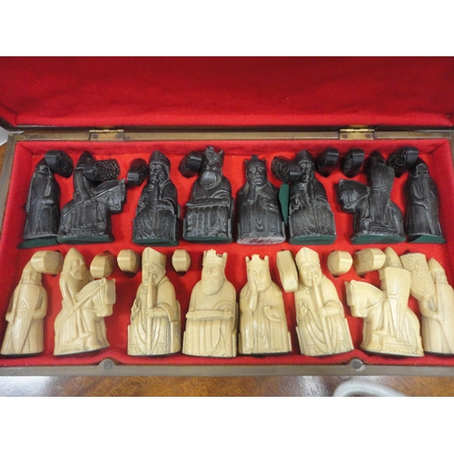 19 - Modern composite chess set modelled after the Lewis chess set, contained within a carved wooden case... 