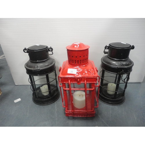 30 - Two cylindrical painted iron carriage lamps and another of square form.&nbsp; (3)