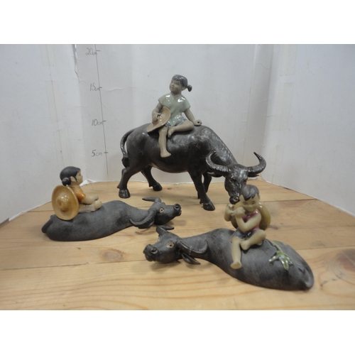 52 - Group of Chinese-style water buffalo figures, a Beneagles whisky bottle in the form of a seal etc.