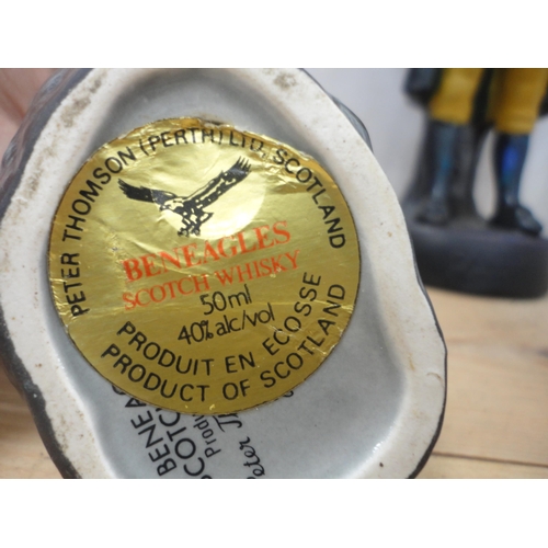 52 - Group of Chinese-style water buffalo figures, a Beneagles whisky bottle in the form of a seal etc.