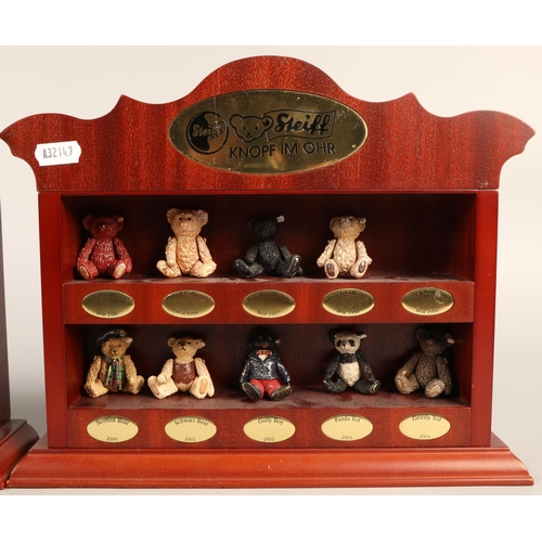 Nineteen miniature Steiff bears, with bags on two miniature display shelves