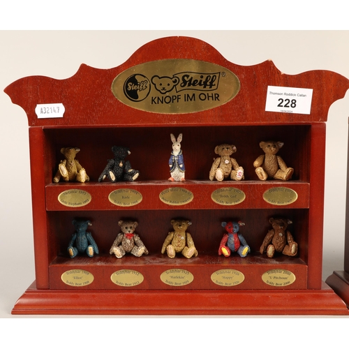 Nineteen miniature Steiff bears, with bags on two miniature display shelves