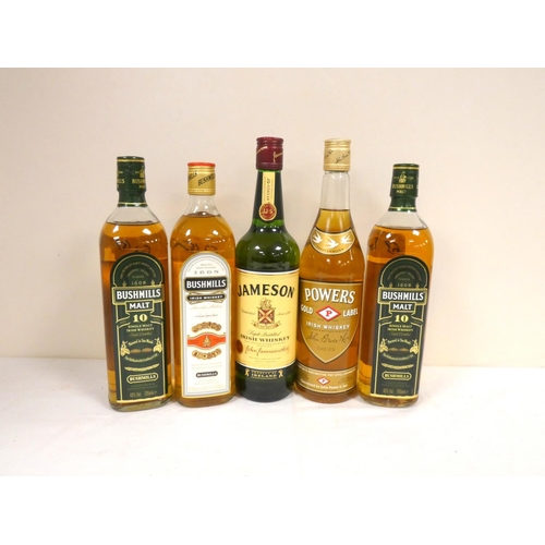 63 - Five bottles of Irish whisky including two bottles of BUSHMILLS Malt 10 year old single malt whiskey... 