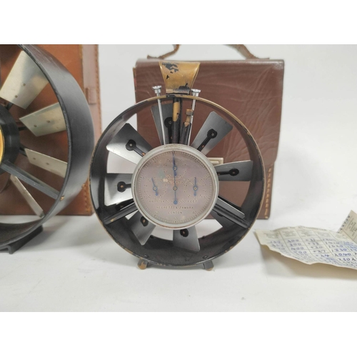 469 - Two early 20th century air speed meters in leather cases the smallest measuring 10cm in diameter and... 