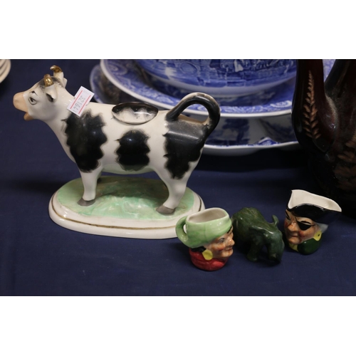 21 - Ceramics to include a Staffordshire cow creamer, a brown glazed, fern decorated, Staffordshire teapo... 