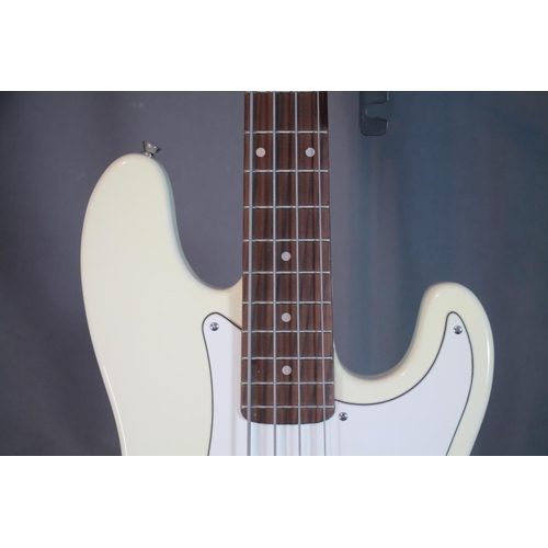 326 - Artisan four string bass guitar with cream and white body in soft case.