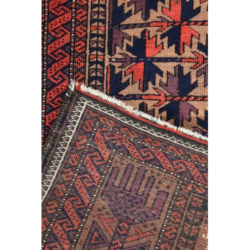 703 - Baluch Persian/Afghan rug, the geometric stylised Tree of Life central pattern within multiple borde... 