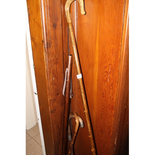 317 - Silver topped walking stick, crook and two others.