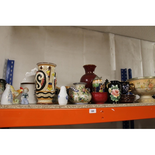 340 - Shelf containing decorative ceramics to include vases, Royal Copenhagen salt, steins, etc.