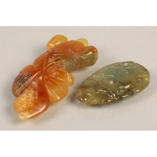 94 - Semi precious stone pendant possibly jade carved in the form of a goat, and another with orange and ... 