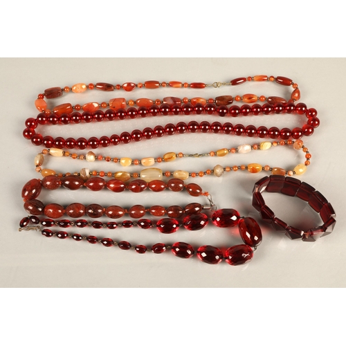 96 - Three red semi precious stone beaded necklaces, a plastic beaded necklace, and a bracelet