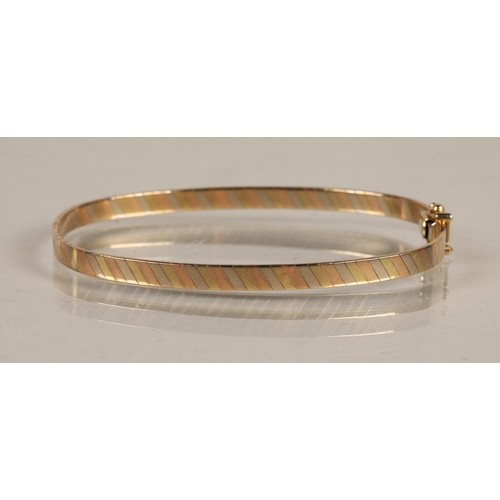 108 - 9ct gold tricolor stiff bangle, 9.4g