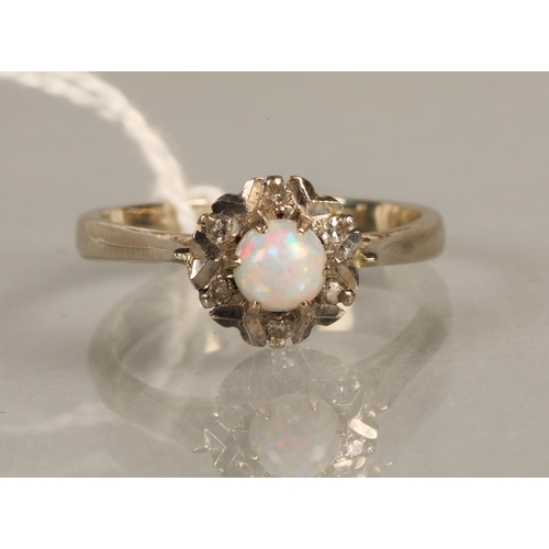 126 - 18ct white gold ring set with a central opal and diamond chips, ring size N