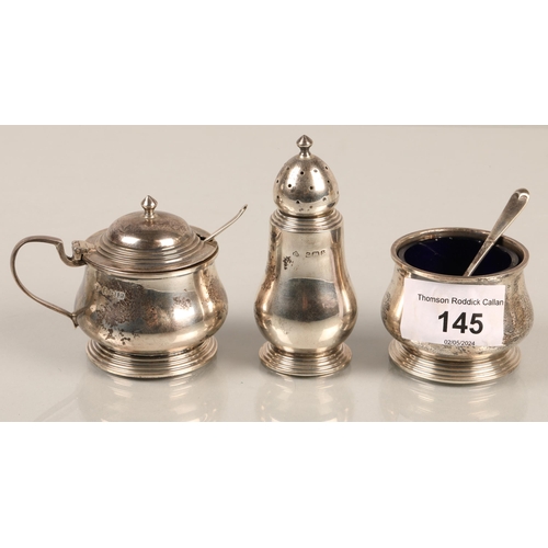 145 - Three piece hallmarked silver cruet set, two salts with glass and spoons, gross weight without glass... 