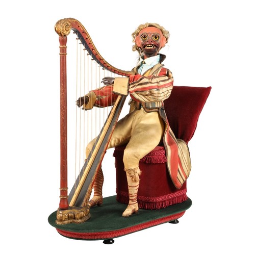 An antique musical automaton in the form of a seated monkey harp player, being a variation on number 17 in the Rouillet et Decamps catalogue. The head moves from side to side and up and down, while the eyes and lips also move. 50cm high, 42cm wide, 23 cm deep.