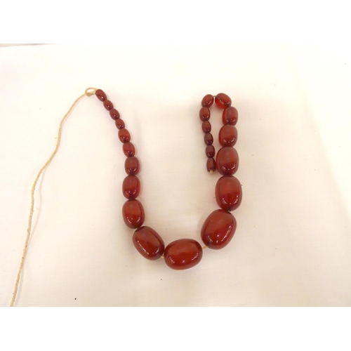 12 - Small bag of cherry amber beads.