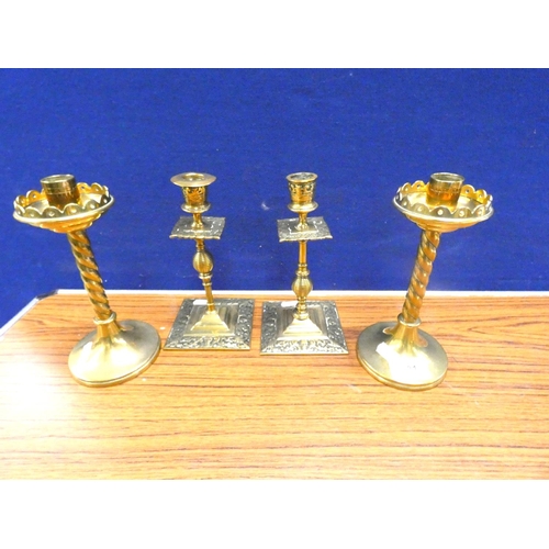 131 - Two pair of antique brass candlesticks.