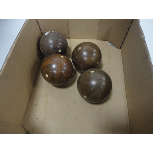 107 - Carton containing four small lignum vitae bowling balls, small globe, ornaments, badges, Linguaphone... 