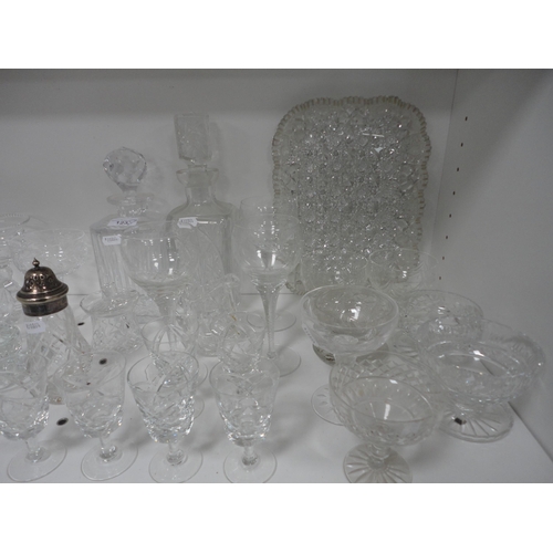 123 - Glassware to include a faceted crystal serving tray, two decanters, brandy glasses, Babycham glasses... 