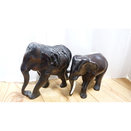 171 - Pair of spiral candlesticks, pair of fire dogs, Indian-style hardwood elephants, coin bank modelled ... 