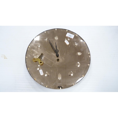 186 - Vintage unframed tinted glass wall mirror and a similar tinted glass wall clock.  (2)