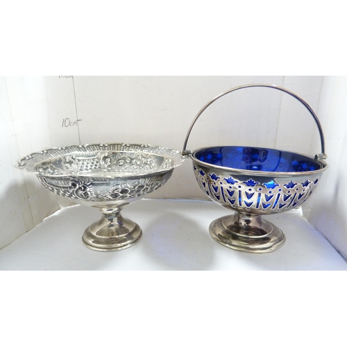 218 - Unmarked white metal embossed stemmed dish and a plated sweetmeat basket with blue glass liner. ... 