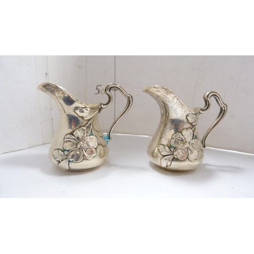 221 - Pair of small Continental silver cream jugs embossed with flowers, stamped '800' to the underside, 5... 