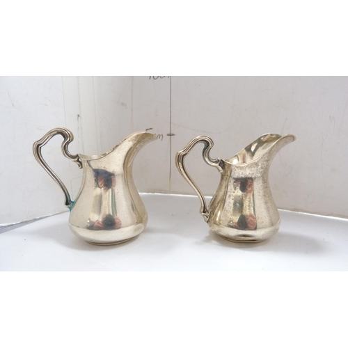 221 - Pair of small Continental silver cream jugs embossed with flowers, stamped '800' to the underside, 5... 