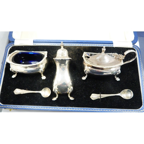 222 - Silver three-piece condiment set with blue glass liners and spoons, in Harrods of London fitted box.