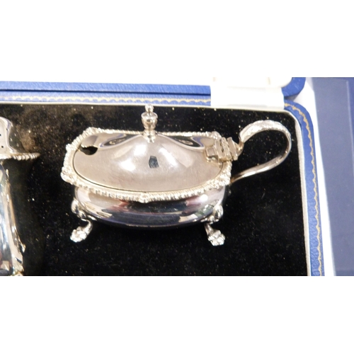 222 - Silver three-piece condiment set with blue glass liners and spoons, in Harrods of London fitted box.