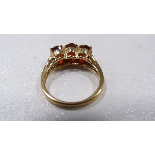 235 - 9ct gold coloured gem-set three-stone lady's ring, 3.8g gross.