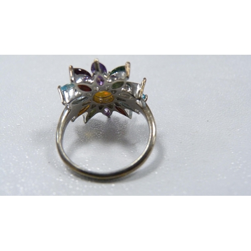 245 - Lady's silver flowerhead dress ring set with faux gemstones, and three pairs of yellow metal earring... 