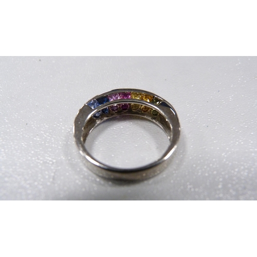 252 - 9ct white gold gem-set half eternity ring with multi-coloured channel-set gemstones, 4.2g gross.