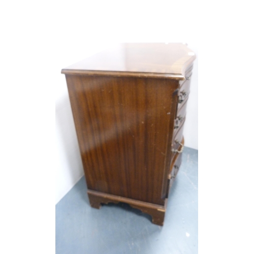 279 - Mahogany serpentine chest of drawers with brushing slide.