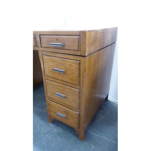 281 - Mid-century oak kneehole desk with tooled skiver to the top.