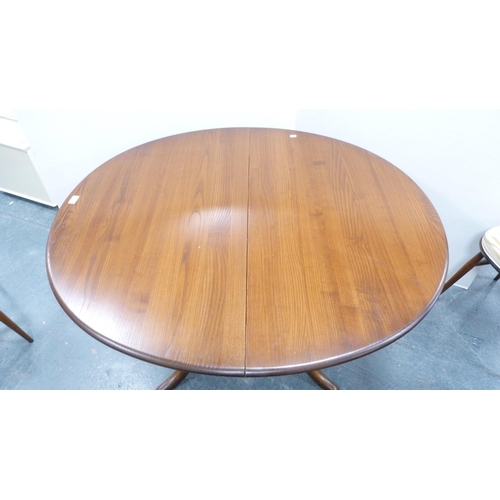 294 - Ercol circular table and four matching Ercol Windsor-style stick-back chairs.  (5)