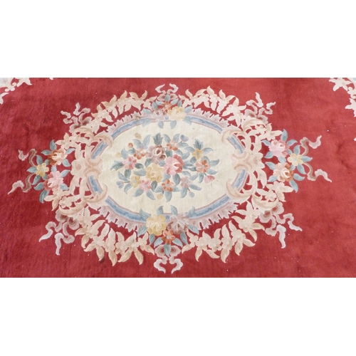 316 - Large Chinese-style carpet on red and cream ground.