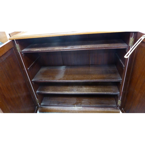 328 - Regency-style mahogany bookcase with two panelled doors.